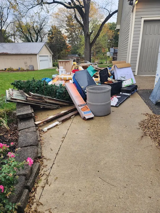 Dumpster being loaded with debris for Demolition Dumpster Rental in Wollochet